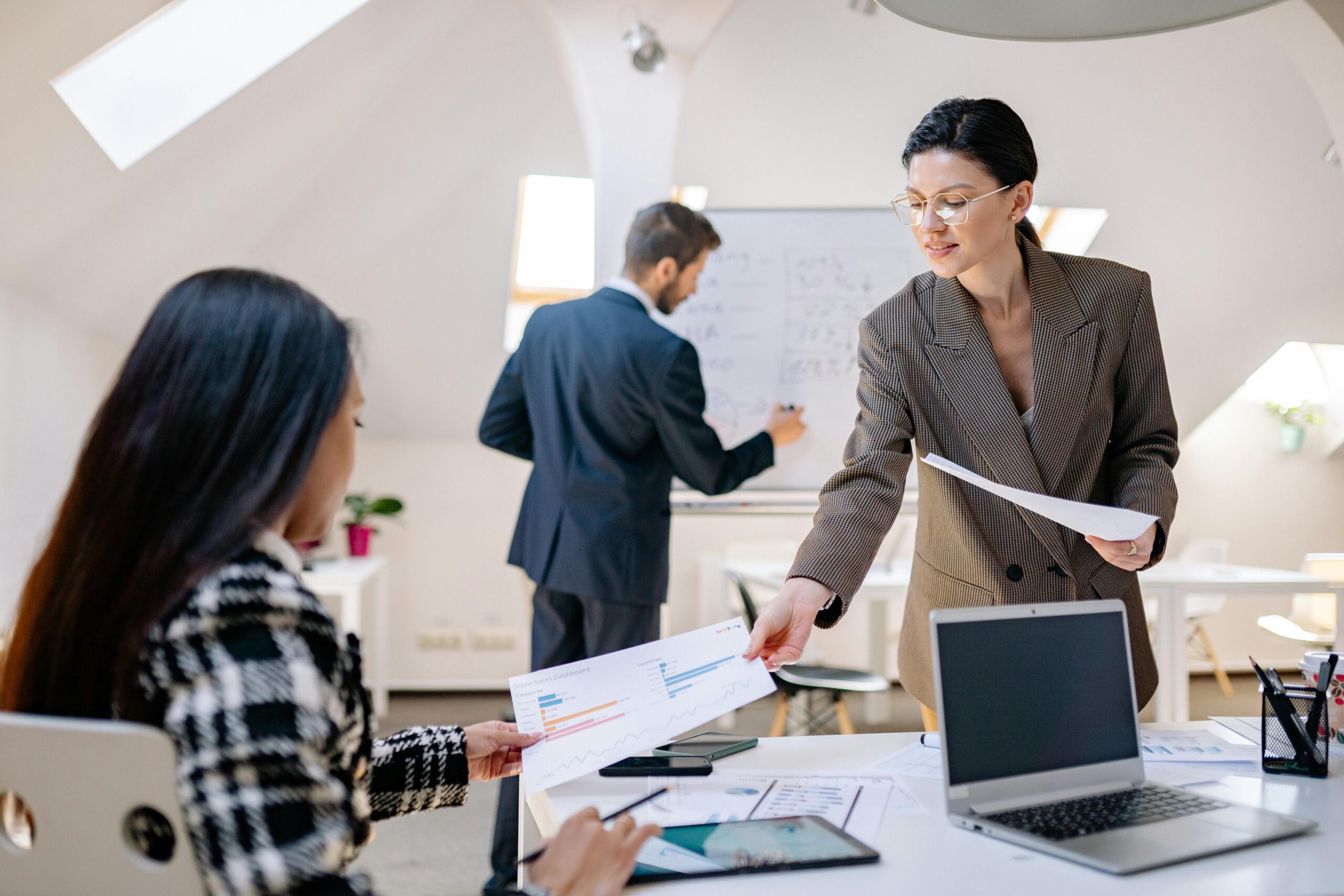 A team lead engaging directly with staff while handing over important papers.